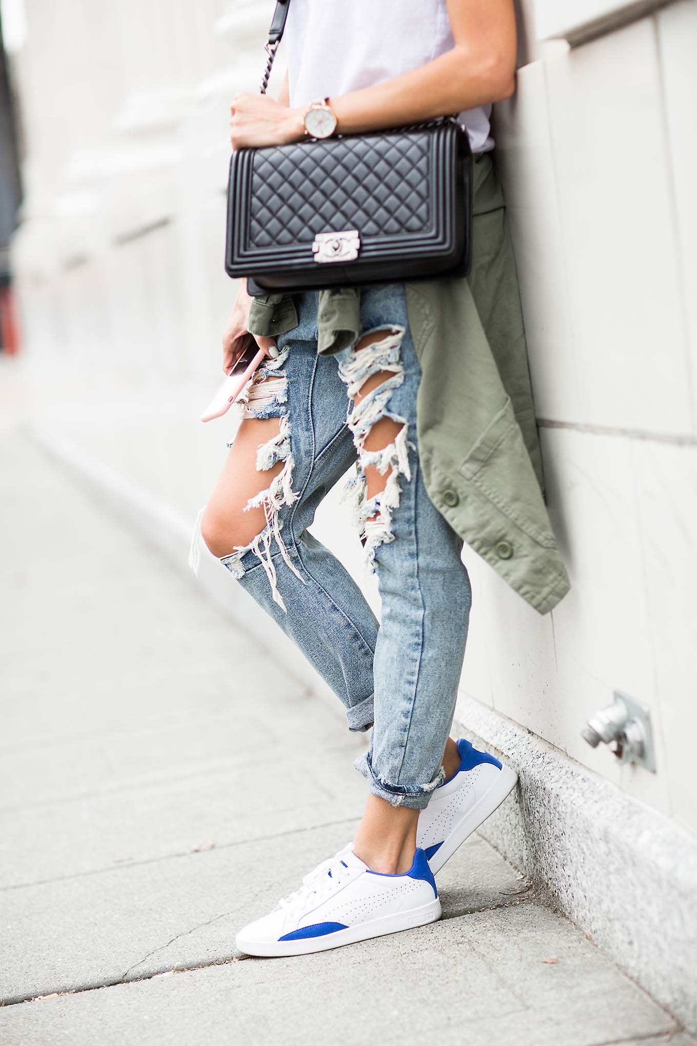 Distressed jeans and sneakers