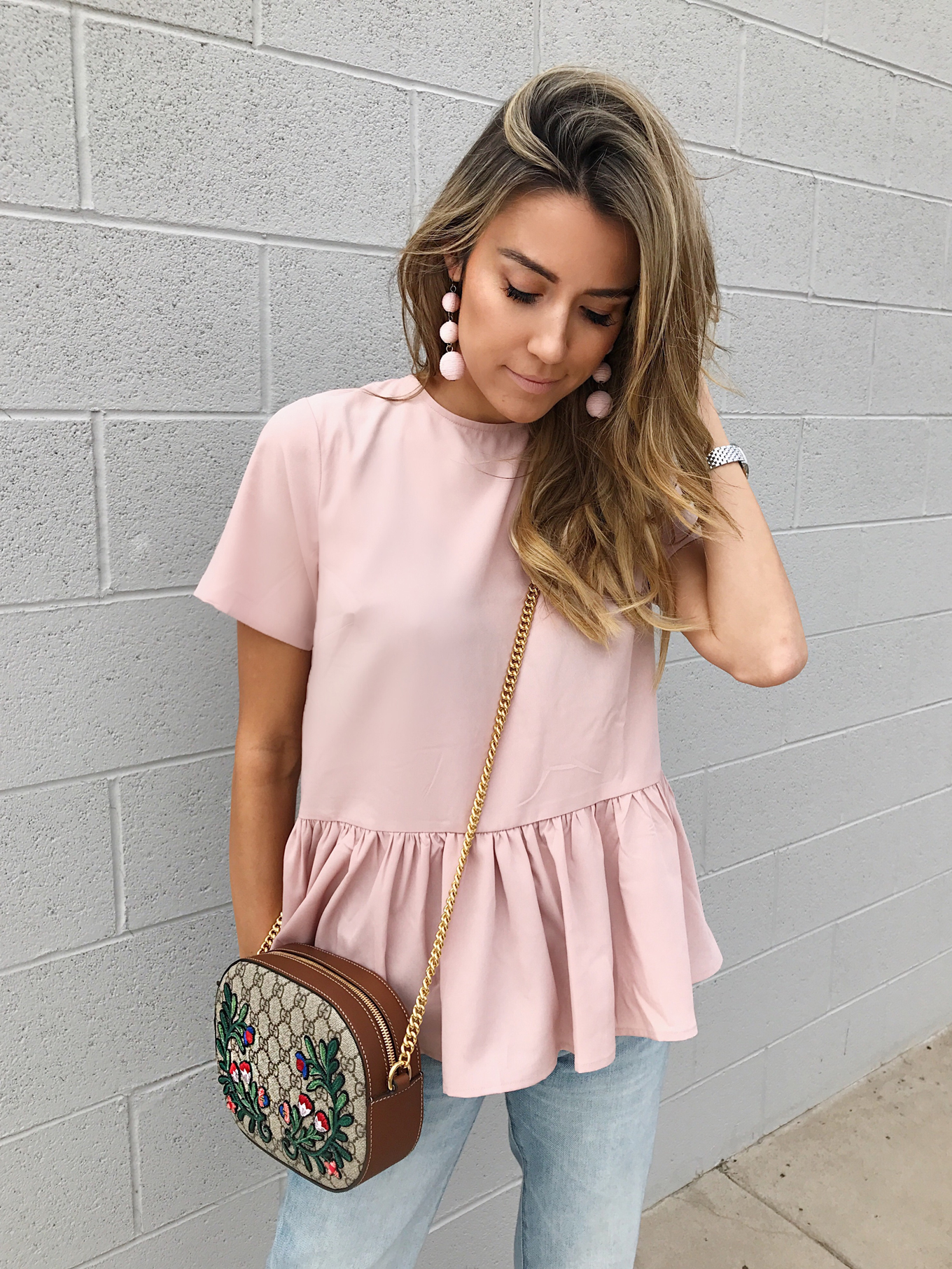 christine andrew in a pink peplum top from Nordstrom