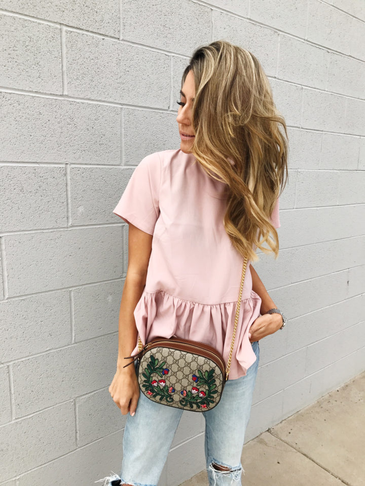 pink peplum top with bow detail