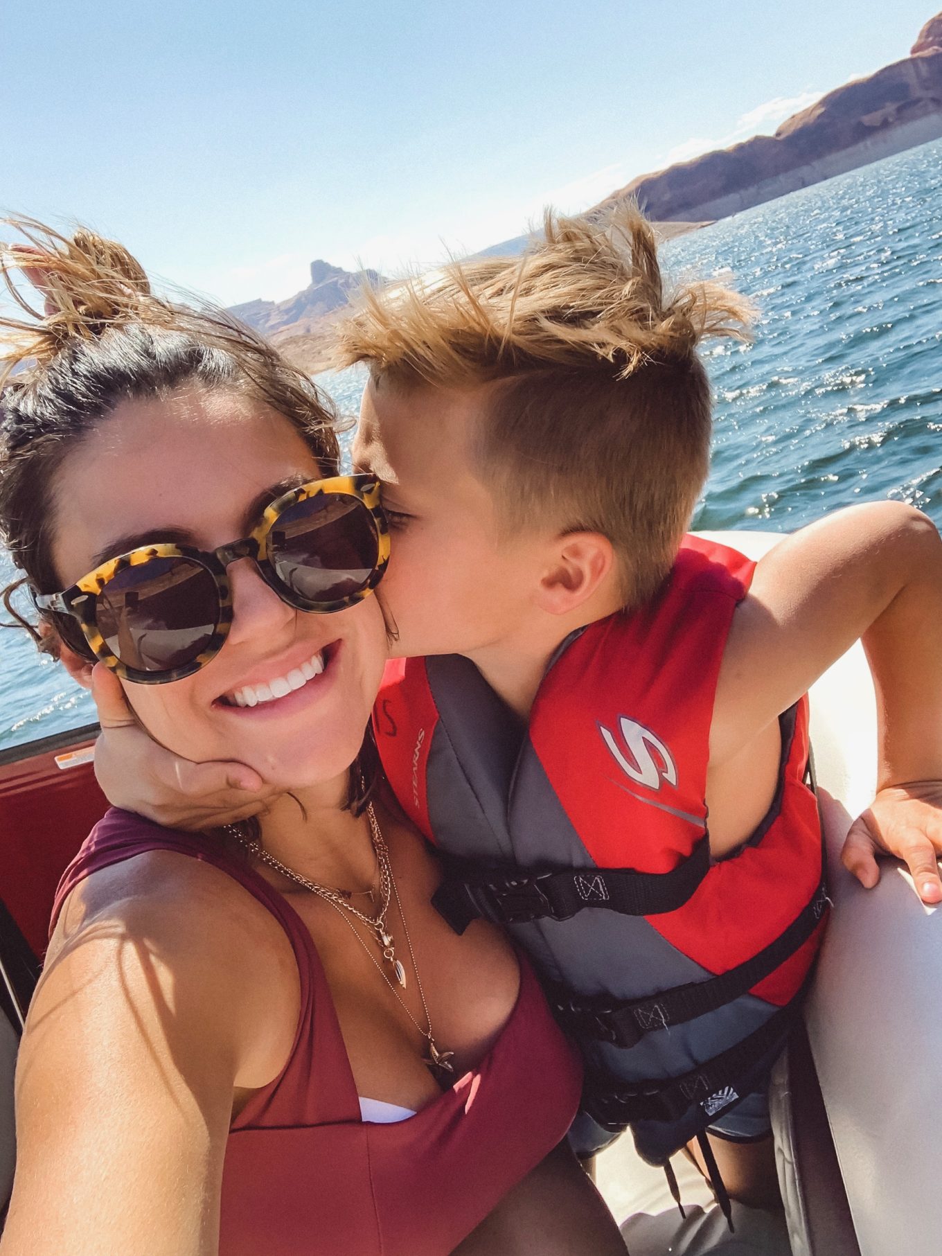 son giving mom a kiss on her cheek