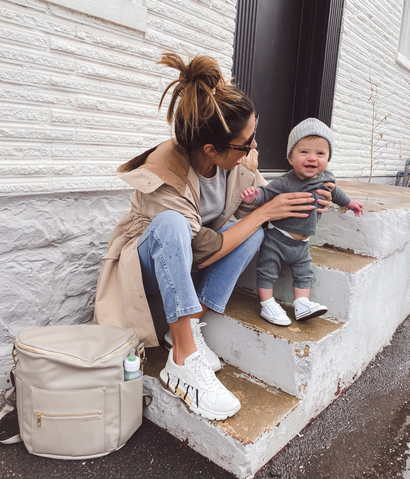 christine andrew and baby with travel bag and diaper bag