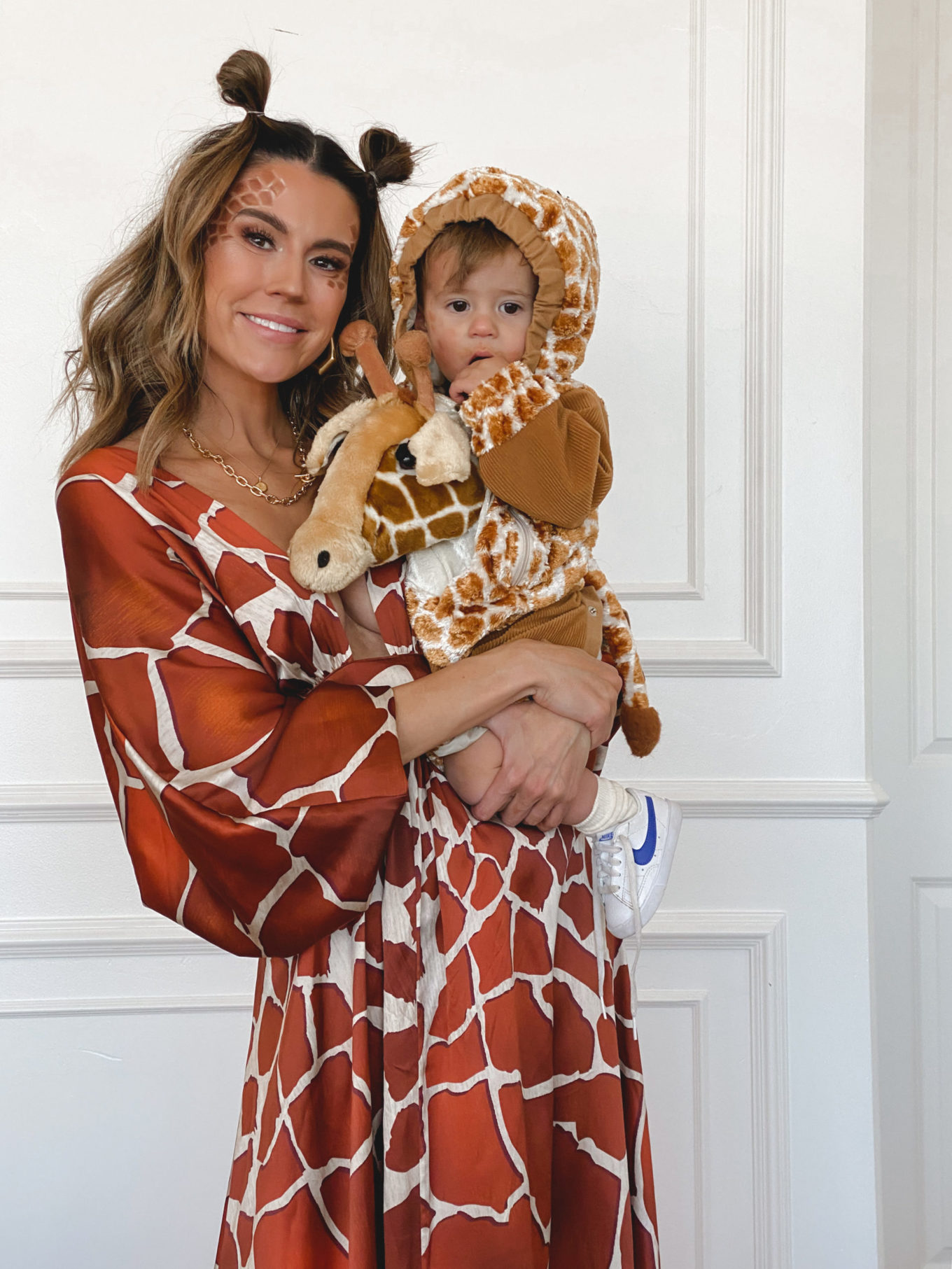 mom and son in matching giraffe halloween costumes