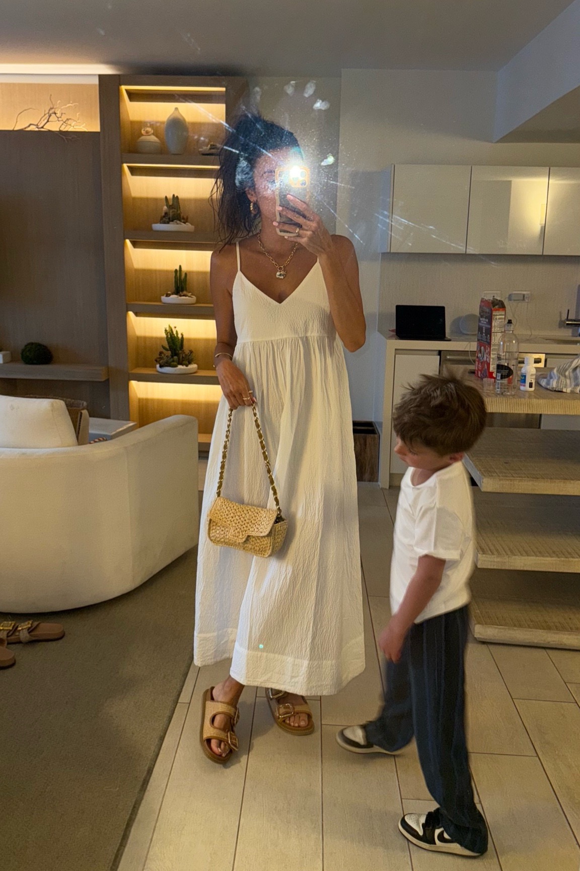 Christine Andrew in an affordable white dress on beach vacation 